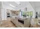 Bright kitchen with stainless appliances, large island, and light wood floors at 9301 E Via Montoya --, Scottsdale, AZ 85255