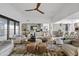Bright open-concept living room with stylish seating, a modern ceiling fan, and hardwood floors at 9301 E Via Montoya --, Scottsdale, AZ 85255