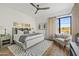 A bedroom features a ceiling fan, a queen bed, and a small couch at 9301 E Via Montoya --, Scottsdale, AZ 85255