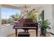 Stylish piano room with a polished grand piano, views of the backyard, and ample natural light at 9301 E Via Montoya --, Scottsdale, AZ 85255