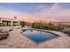 Inviting backyard oasis featuring a sparkling pool, travertine patio, and views of the mountains at sunset at 9301 E Via Montoya --, Scottsdale, AZ 85255
