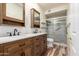 Bathroom featuring double sinks, vanity, and walk-in shower at 9455 E Raintree Dr # 1025, Scottsdale, AZ 85260