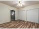 Spacious bedroom with wood-look floors, closet, and patio door at 9455 E Raintree Dr # 1025, Scottsdale, AZ 85260