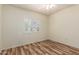 Cozy bedroom with wood-look floors and shuttered window at 9455 E Raintree Dr # 1025, Scottsdale, AZ 85260