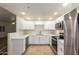 Modern kitchen with stainless steel appliances and sleek white cabinets at 9455 E Raintree Dr # 1025, Scottsdale, AZ 85260