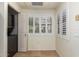 Laundry room with gray washer/dryer, storage, and shuttered window at 9455 E Raintree Dr # 1025, Scottsdale, AZ 85260