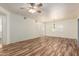 Bright living room with wood-look flooring, a ceiling fan, and views of other rooms at 9455 E Raintree Dr # 1025, Scottsdale, AZ 85260