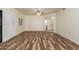 Large living room with wood-look flooring, ceiling fan, and access to other rooms at 9455 E Raintree Dr # 1025, Scottsdale, AZ 85260