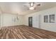 Spacious living room with wood-look flooring, plantation shutters, and a ceiling fan at 9455 E Raintree Dr # 1025, Scottsdale, AZ 85260