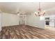 Open living room with wood-look floors, chandelier, and easy access to the kitchen at 9455 E Raintree Dr # 1025, Scottsdale, AZ 85260
