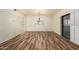 Spacious living area with wood-look flooring, a chandelier, and a sliding glass door at 9455 E Raintree Dr # 1025, Scottsdale, AZ 85260