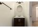 Charming powder room featuring dark wood vanity and round mirror at 9455 E Raintree Dr # 1025, Scottsdale, AZ 85260