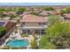 Aerial view of the backyard oasis with a pool, spa, patio, and meticulously landscaped grounds at 10415 E Rosemary Ln, Scottsdale, AZ 85255