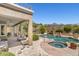 Backyard pool with waterfall, outdoor kitchen, covered patio and mountain views at 10415 E Rosemary Ln, Scottsdale, AZ 85255