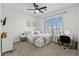 Bedroom featuring a ceiling fan, carpeted floors, window with shutters, desk, and modern decor at 10415 E Rosemary Ln, Scottsdale, AZ 85255