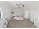 Bright bedroom featuring a ceiling fan, white walls, carpeted floors, desk, and closet at 10415 E Rosemary Ln, Scottsdale, AZ 85255