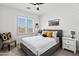 Relaxing bedroom featuring a ceiling fan, carpeted floors, window with shutters, and stylish furniture at 10415 E Rosemary Ln, Scottsdale, AZ 85255