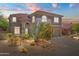 Charming two-story home with a desert landscaped yard, archway entry and a red tile roof at 10415 E Rosemary Ln, Scottsdale, AZ 85255