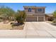 Two-story home featuring a tile roof, a two-car garage, and desert landscaping at 10415 E Rosemary Ln, Scottsdale, AZ 85255