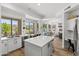 Open kitchen with a large island, stainless steel appliances, and views of the backyard and dining area at 10415 E Rosemary Ln, Scottsdale, AZ 85255