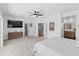 Large main bedroom with ceiling fan, leading to en-suite bath and hallway at 10415 E Rosemary Ln, Scottsdale, AZ 85255