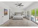 Spacious main bedroom with ceiling fan, private balcony access, and neutral decor at 10415 E Rosemary Ln, Scottsdale, AZ 85255