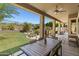 Relaxing covered patio featuring an outdoor dining area and views of the landscaped backyard at 10415 E Rosemary Ln, Scottsdale, AZ 85255
