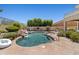Refreshing pool oasis equipped with a rock waterfall feature and convenient step-in access at 10415 E Rosemary Ln, Scottsdale, AZ 85255