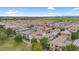 Aerial view of a residential neighborhood shows a vast expanse of tile-roofed homes under a clear sky with green spaces at 1069 S Nancy Ln, Gilbert, AZ 85296