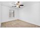 Bedroom featuring neutral carpeting and a window with plantation shutters at 1069 S Nancy Ln, Gilbert, AZ 85296