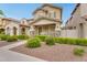 Inviting two-story home featuring stone accents, a cozy porch, and manicured landscaping at 1069 S Nancy Ln, Gilbert, AZ 85296