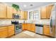 Well-equipped kitchen with stainless steel appliances and wood cabinets at 1069 S Nancy Ln, Gilbert, AZ 85296