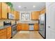 Functional kitchen featuring stainless steel appliances, tile backsplash, and ample cabinet space at 1069 S Nancy Ln, Gilbert, AZ 85296