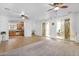 Spacious living room with ceiling fans, carpeted floors, and backyard access at 1069 S Nancy Ln, Gilbert, AZ 85296