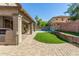 Private backyard featuring a covered patio, built-in barbecue, lush lawn, and sparkling pool at 11580 N 145Th Ave, Surprise, AZ 85379