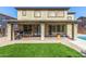 A covered patio and artificial turf highlight the backyard's features, offering a low-maintenance outdoor space at 11580 N 145Th Ave, Surprise, AZ 85379