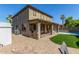 Expansive backyard featuring a covered patio, well-manicured lawn, brick pavers, and a refreshing swimming pool at 11580 N 145Th Ave, Surprise, AZ 85379