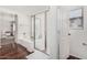 Modern bathroom with a glass-enclosed shower, soaking tub, and white color scheme at 11580 N 145Th Ave, Surprise, AZ 85379