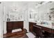 Bathroom with dark wood cabinets, marble countertops, dual sinks and vanity area at 11580 N 145Th Ave, Surprise, AZ 85379