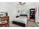 Bedroom features a ceiling fan, desk, and a comfy bed at 11580 N 145Th Ave, Surprise, AZ 85379