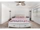 Bright bedroom featuring ceiling fan, dual bedside tables with lamps, and comfy bed at 11580 N 145Th Ave, Surprise, AZ 85379