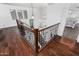 Hallway with wood floors and wrought iron railing provides views to the lower level at 11580 N 145Th Ave, Surprise, AZ 85379