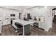 Bright kitchen featuring white cabinets, stainless steel appliances, and a spacious island at 11580 N 145Th Ave, Surprise, AZ 85379