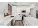 Modern kitchen with stainless steel appliances, white cabinets, and quartz countertops at 11580 N 145Th Ave, Surprise, AZ 85379