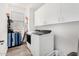 Bright laundry room with modern appliances, white cabinetry and natural light at 11580 N 145Th Ave, Surprise, AZ 85379