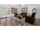 Sunlit living room offers wood-style floors, ceiling fan, and stylish window shutters at 11580 N 145Th Ave, Surprise, AZ 85379