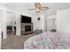 Cozy bedroom with a fireplace, ceiling fan, and connected views to the bathroom and closet at 11580 N 145Th Ave, Surprise, AZ 85379