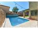 A private pool is framed by string lights creating a relaxing outdoor ambiance in the backyard at 11580 N 145Th Ave, Surprise, AZ 85379