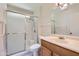 Bathroom with glass enclosed shower, tile floors and single sink vanity at 13631 N 103Rd Ave, Sun City, AZ 85351