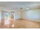 Living room with hardwood floors, neutral walls, ceiling fan and access to outdoor patio at 13631 N 103Rd Ave, Sun City, AZ 85351